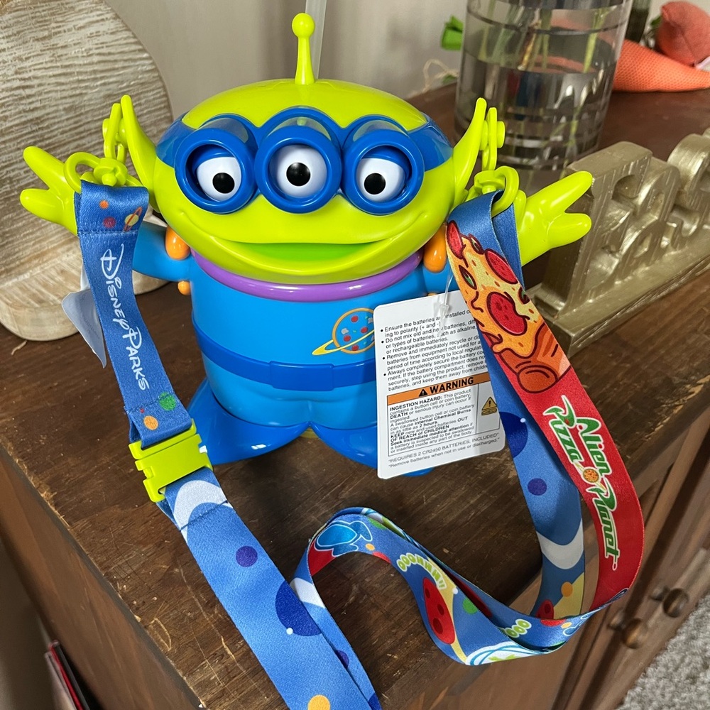 NWT Disney Alien refillable sipper with reversible carrying strap and lights up.